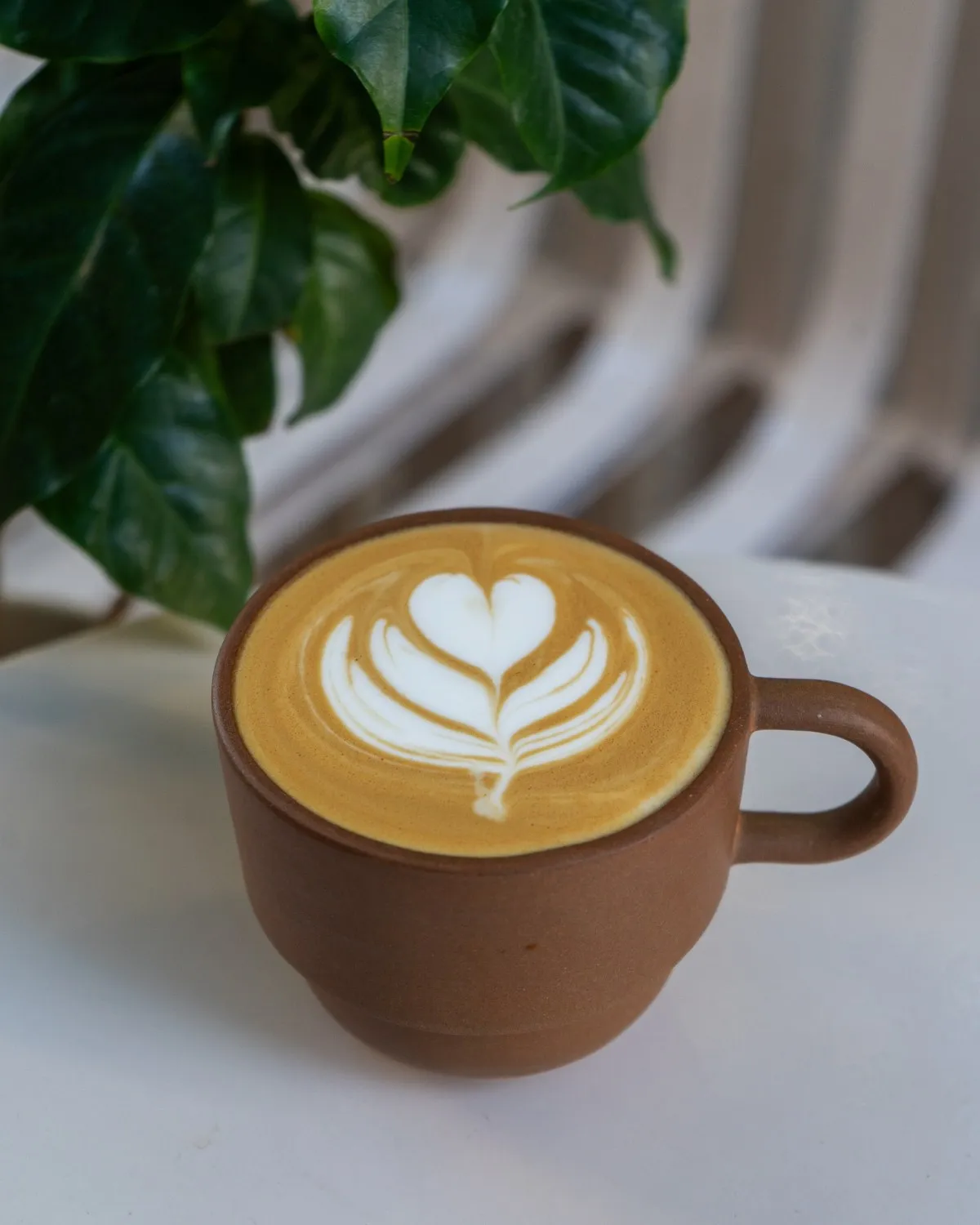 Bold flat white with latte art, in a ceramic cup