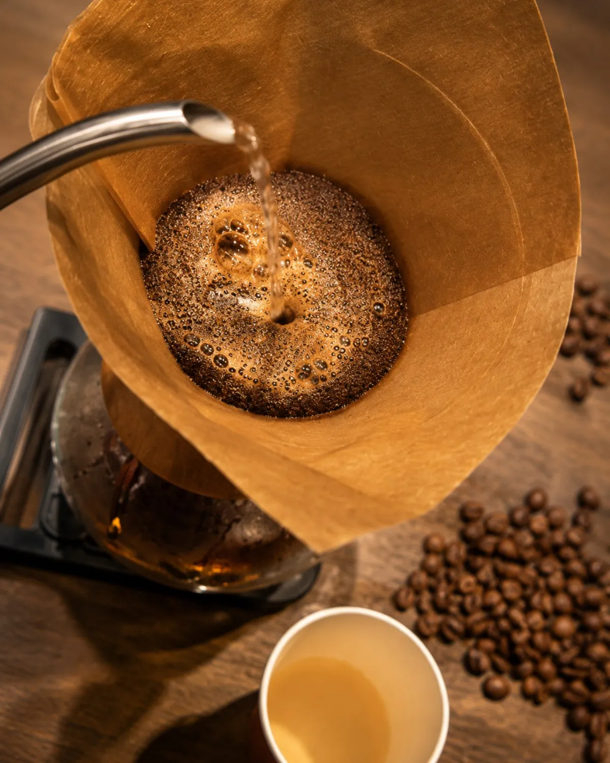 Filter coffee being brewed pour over, with coffee beans